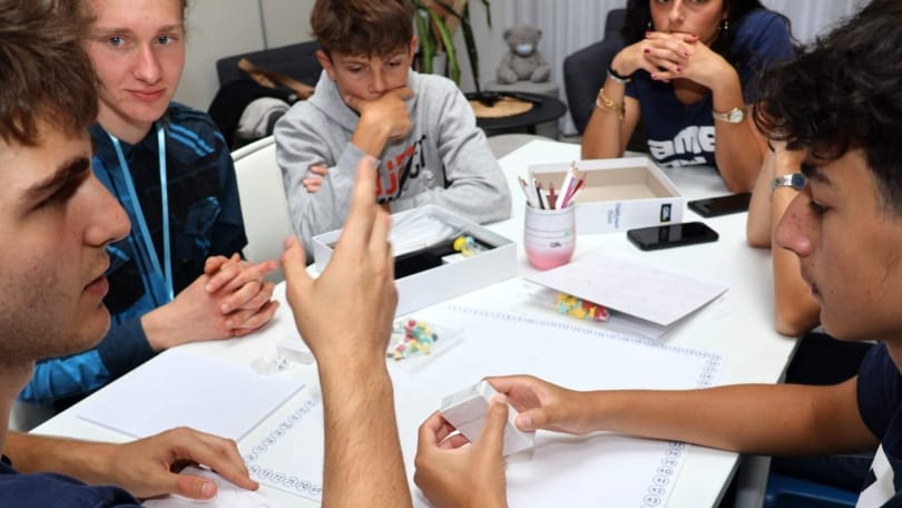 PlayQuest participants developing and discussing a board game prototype during a creative workshop in Prague